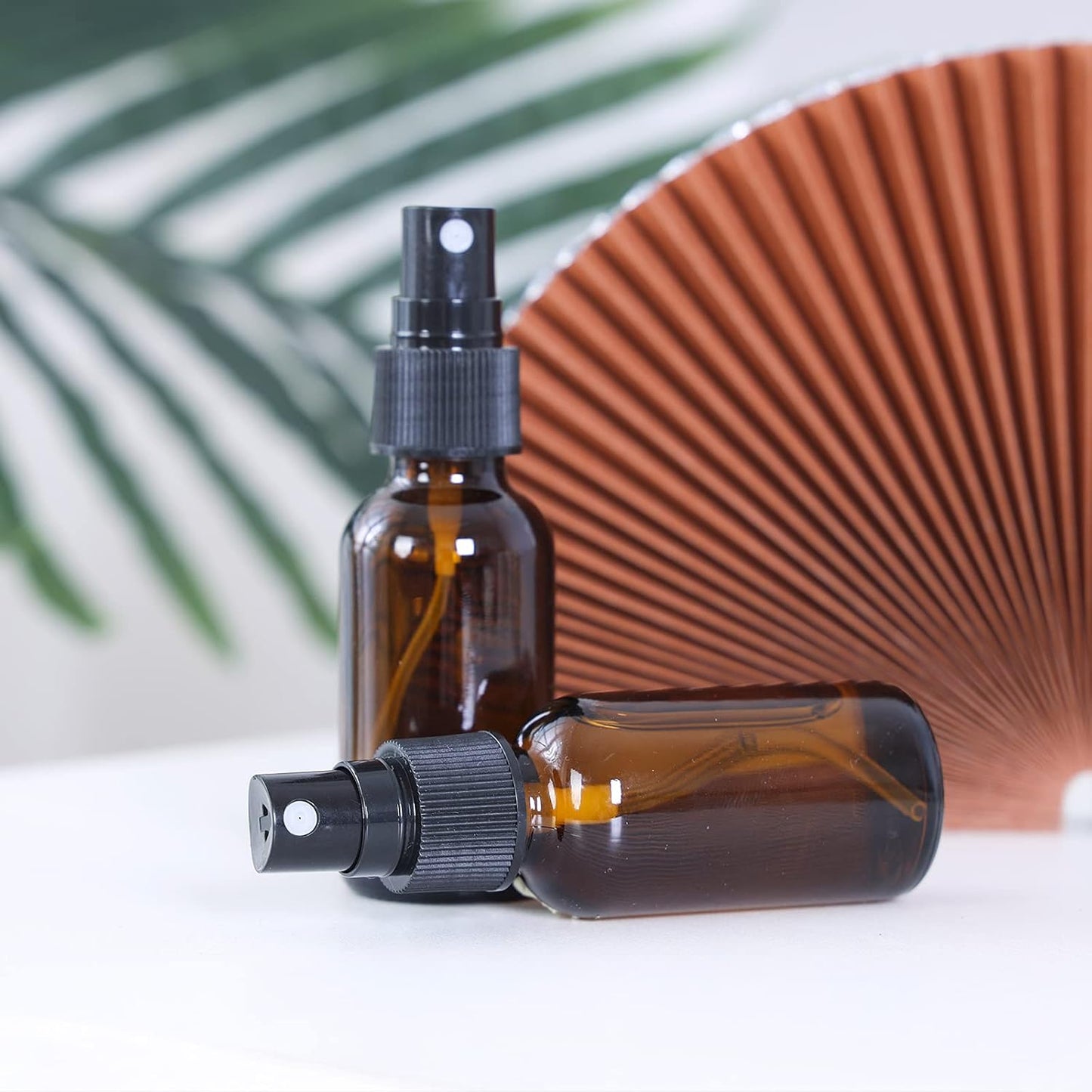 2oz Glass Spray Bottle, Fine Mist Boston Glass Bottles with Black Fine Mist Sprayer Small Clear Bottles for Essential Oils, Bath, Beauty, Hair & Cleaning, Amber, Pack of 24